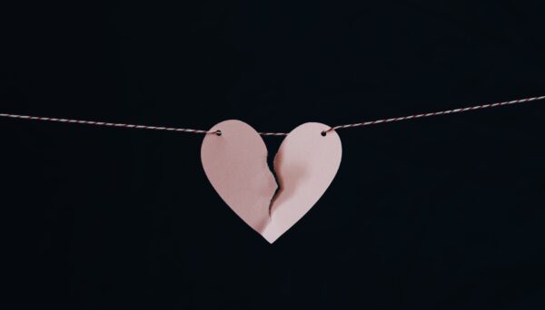 A close up of a broken paper heart hanging from a rope. Affair recovery in West Des Moines, IA can help you repair your relationship. Learn more about affair recovery counseling in West Des Moines, IA by contacting an infidelity counselor today! 50266