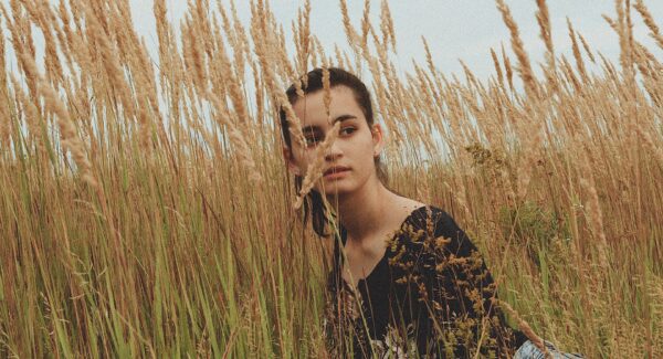 A young woman looks off through a wheat field. This could represent the isolation caused by anxiety. Treatment in Des Moines, IA can offer support with. Contact an anxiety therapist for more therapy about online anxiety therapy including methods on how to treat anxiety.