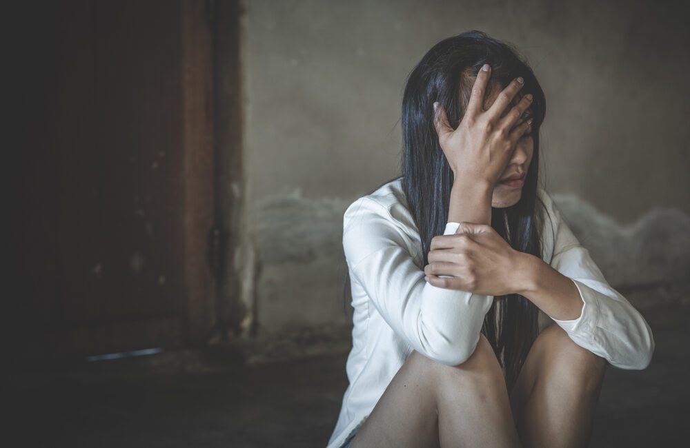 A woman sits with her hand against her face. Depression counseling in West Des Moines, IA can offer support in overcoming depression.