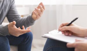 Man talking to therapist about his ADHD behavior. The Relationship & Intimacy Center in West Des Moines, IA can help you manage your ADHD. 