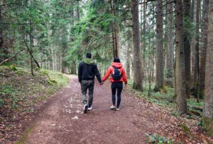 A couple hold hands as they hike down a trail. This could represent the success of affair recovery in West Des Moines, IA. Learn more about affair recovery counseling in West Des Moines, IA and other services. An infidelity counselor in West Des Moines, IA can offer support. 50266