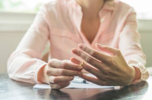 A close up of a person adjusting their wedding ring. This could represent the desire to come clean about infidelity. Affair recovery in West Des Moines, IA can offer support with infidelity counseling in West Des Moines, IA and other services. Learn more about affair recovery counseling by contacting an infidelity counselor in West Des Moines, IA. 50266