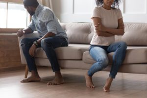 A couple sitting on the same sofa look away from one another as they appear to be arguing. Affair recovery in West Des Moines, IA can offer support with infidelity counseling in West Des Moines, IA. Contact an infidelity counselor for support today with affair recovery counseling in West Des Moines, IA! 50266
